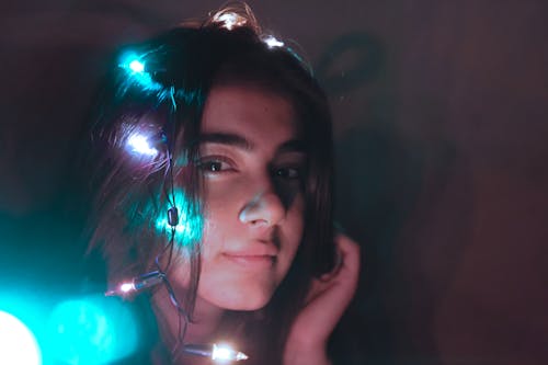 Woman Holding Her Hair With Dim Background