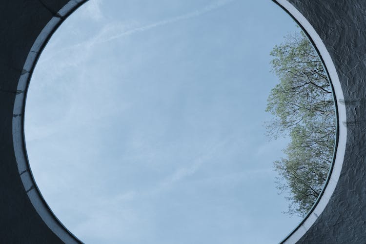 Photo Of The Sky Seen Through A Circle Roof Window