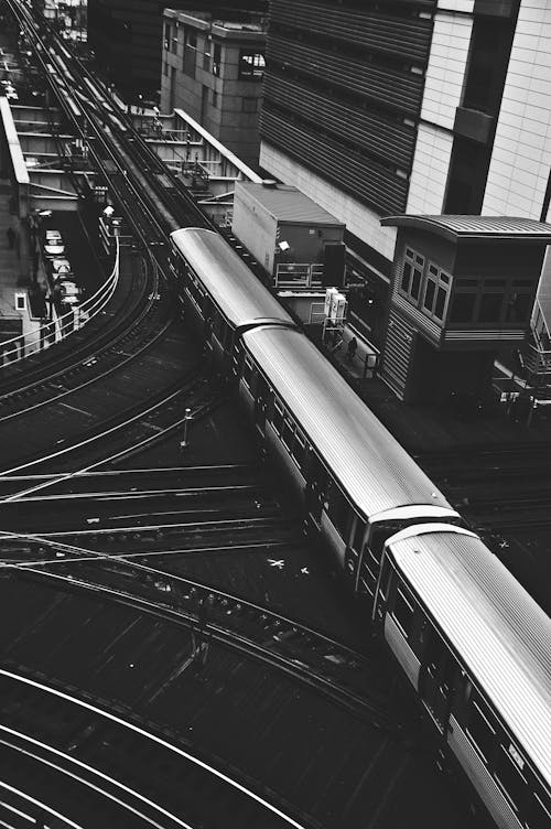 Free Grayscale Photography Of Train Beside Building Stock Photo