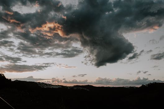 Captivating dawn view with dramatic cloud formations over a scenic landscape.