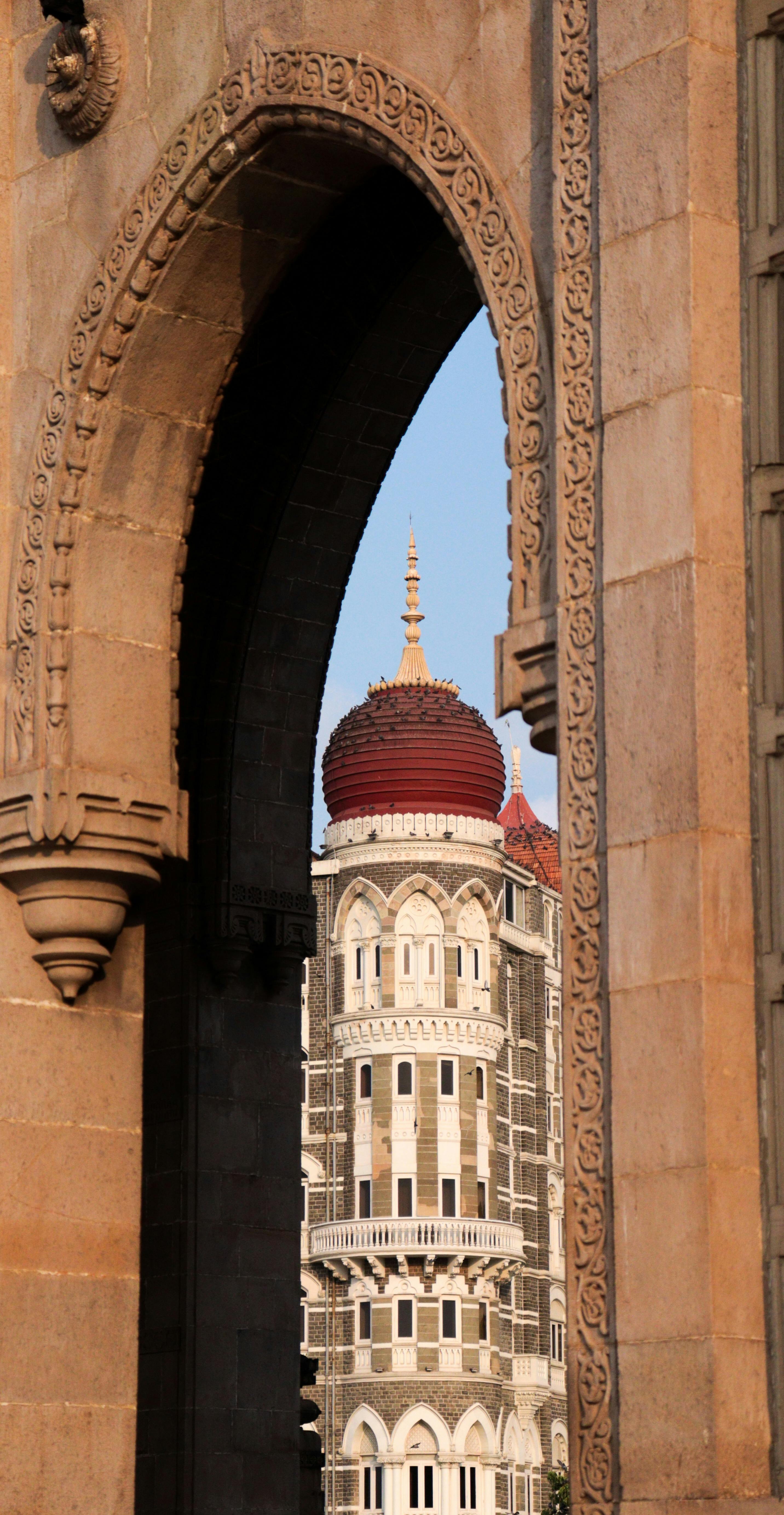 taj mahal palace hotel seen through gateway of india in mumbai