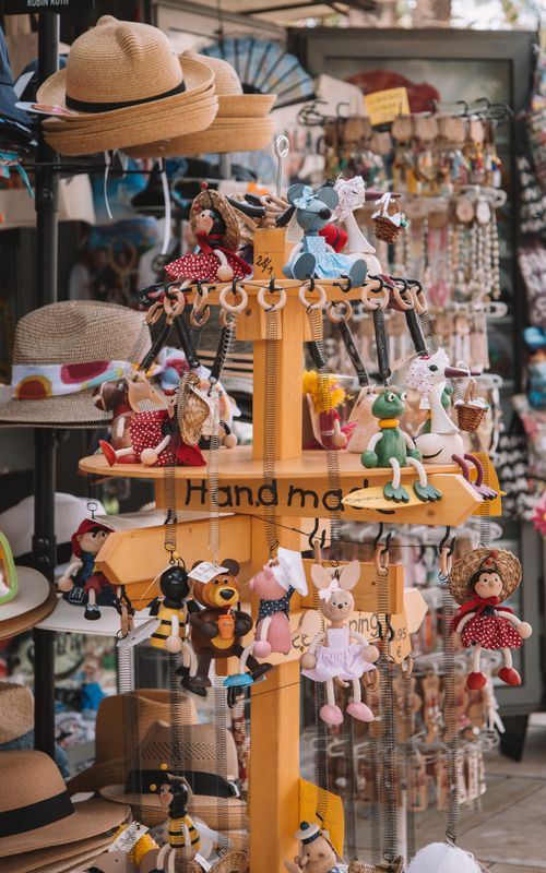Free Vibrant handmade toys and souvenirs showcase in a sunny Málaga shop. Stock Photo