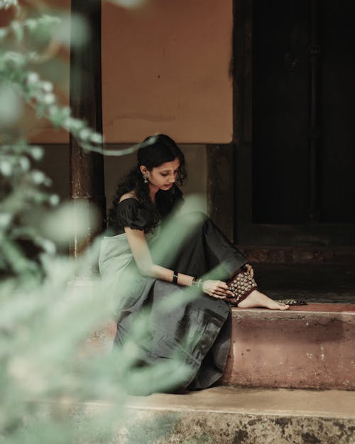 Classical Indian Dancer Putting On an Ghungroo Anklet with Bells