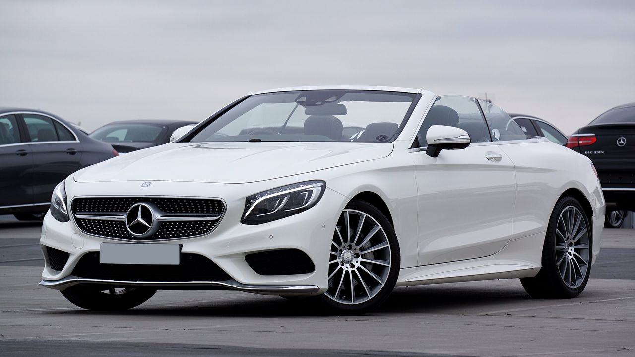 elegant white mercedes benz convertible parked outdoors showcasing lux