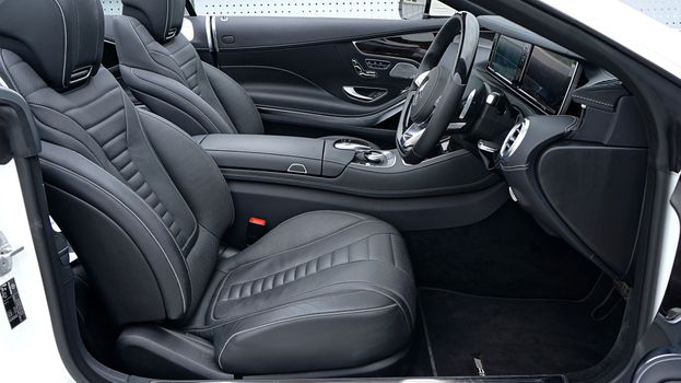 Explore the sleek and modern interior of a luxurious Mercedes-Benz, featuring premium black leather seats and a stylish dashboard.