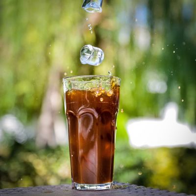 A vibrant iced drink splashing out of a glass — photo by aidin gheshlaghi on Pexels