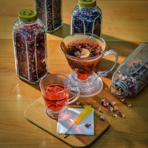 Tea in Glasses by Herbs in Glass Bottles