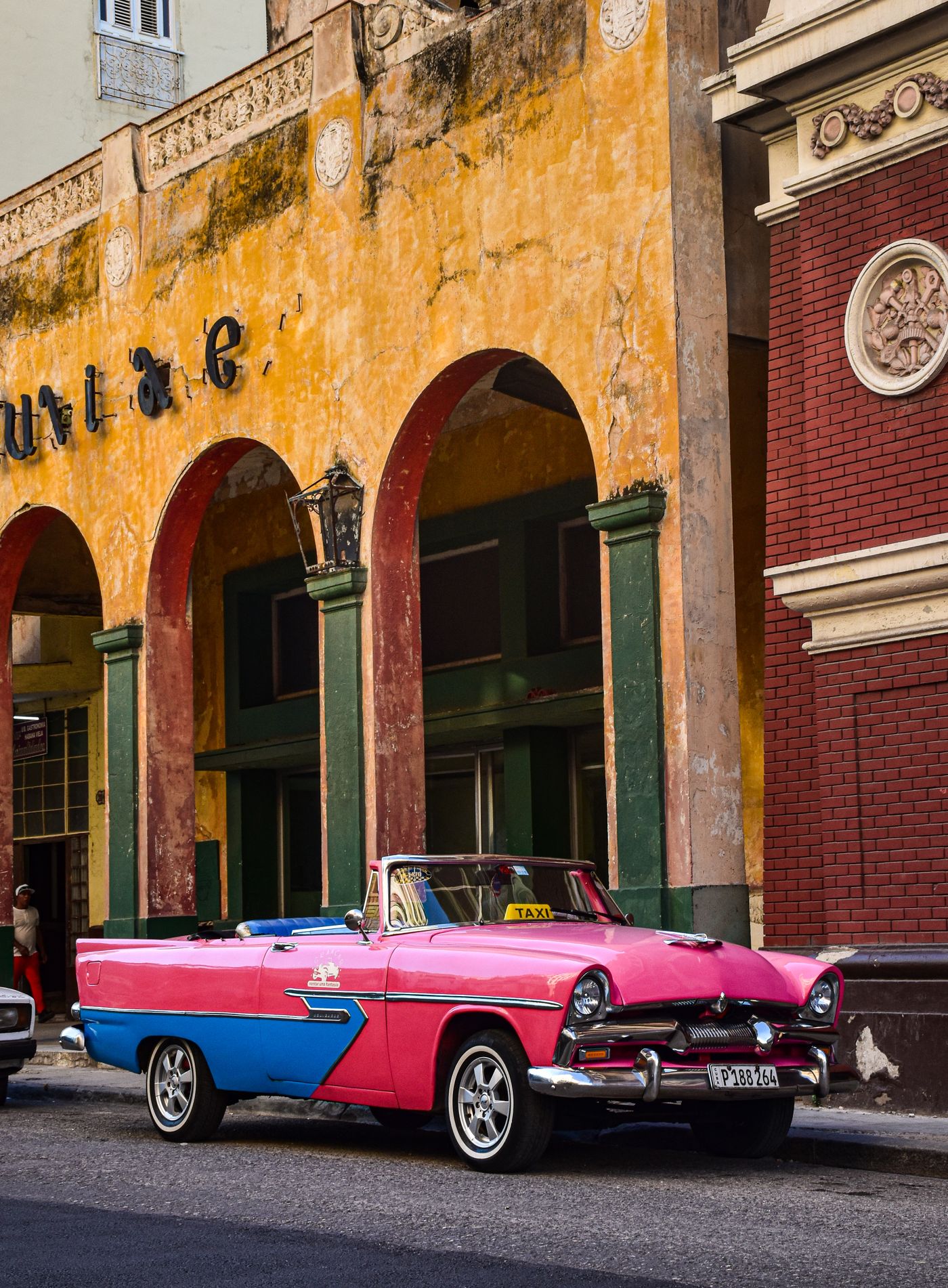 Can I Travel to Cuba? What Canadians Actually Need in 2026-2027 2 Classic 1950s car parked on a colorful street in Old Havana, Cuba