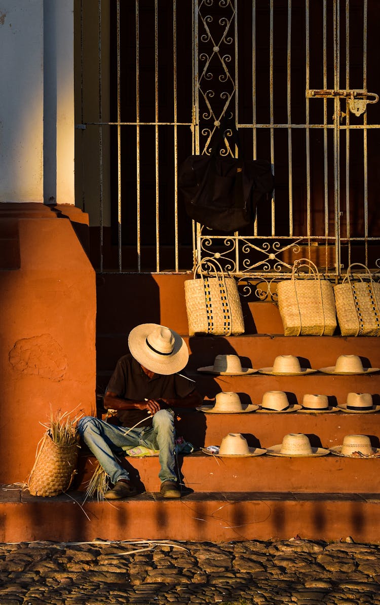 Artisan Selling Straw Hats And Bags