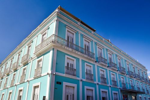 Free Stunning pastel blue colonial building in Cienfuegos, Cuba under a clear blue sky. Stock Photo