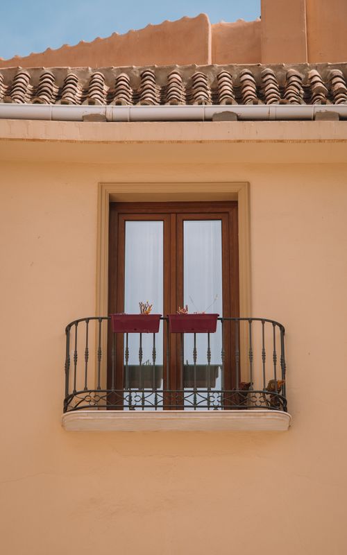 Free A beautiful balcony with ornate railing and classic Spanish architecture in Málaga, Spain. Stock Photo