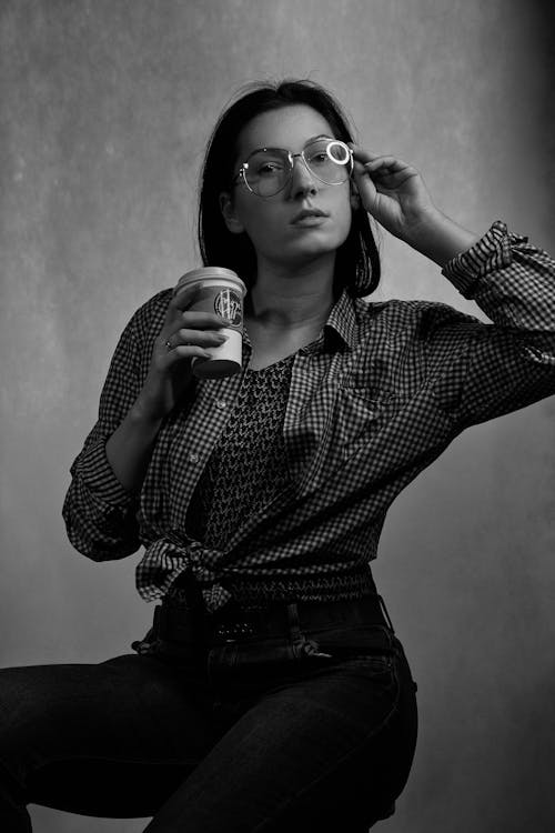 бесплатная Женщина, держащая чашку и очки Стоковое фото