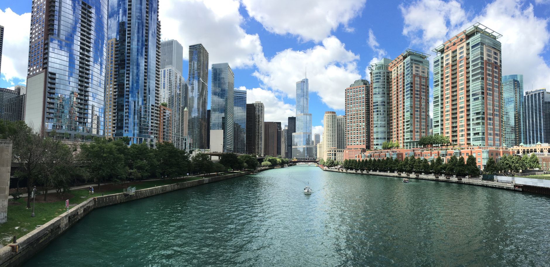 Stunning view of Chicago skyline along the river under a clear blue sky.
