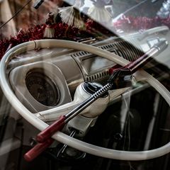 A bar-style steering lock fitted across a car's steering wheel