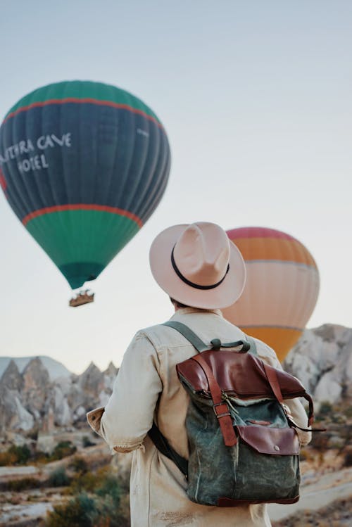 Back View of a Person Watching Hot Air Balloons Flying over Cappadocia, Turkey 