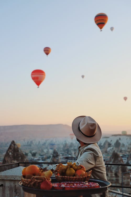 Back View of a Person Watching Hot Air Balloons Flying over Cappadocia, Turkey