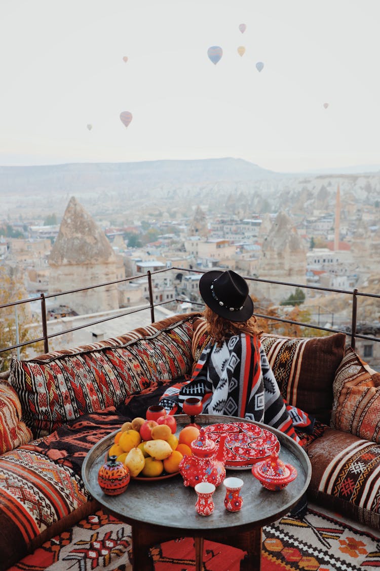 Woman Sitting On A Terrace And Looking At The Landscape Of Cappadocia 