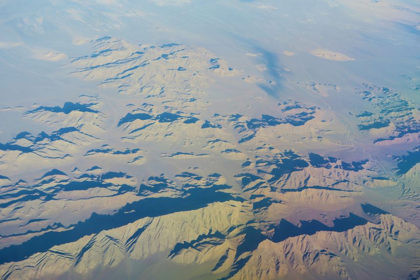 Aerial view of a snow-covered mountain range — photo by Konevi on Pexels