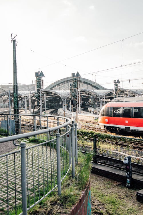 A red train traveling through a train station