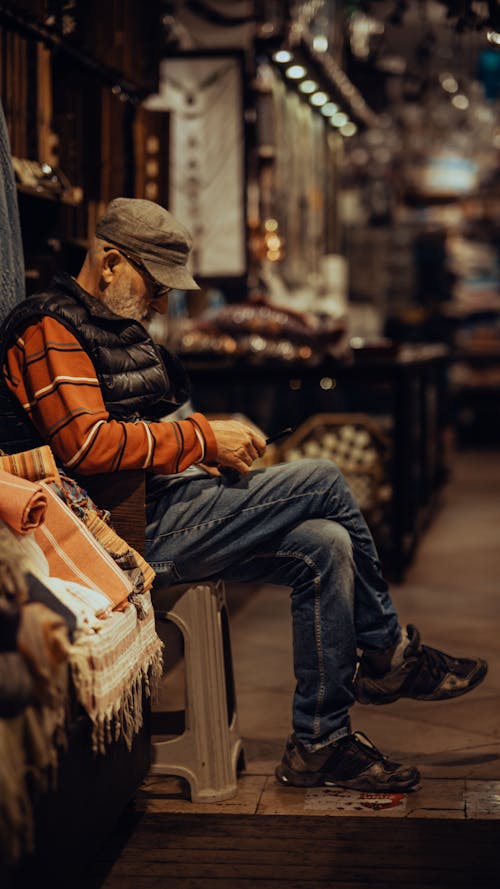 Man Sitting at the Market in the Evening 