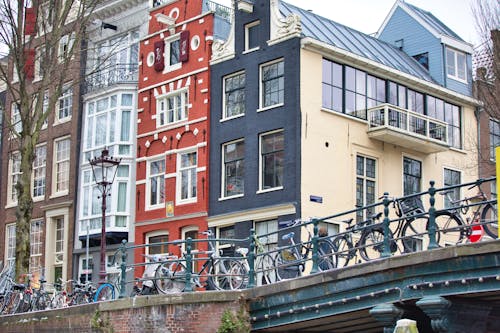 Traditional Buildings and Bridge with Bicycles seen from the Canal in Amsterdam, Netherlands 