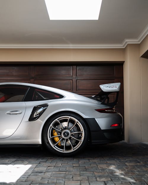 A Gray Sports Car Parked in a Garage 