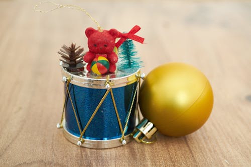 Blue Drum and Yellow Ornaments Placed on Wood