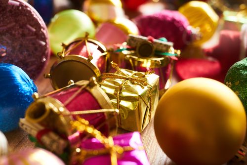 Free Colorful display of Christmas decorations featuring gift boxes, drums, and baubles. Stock Photo