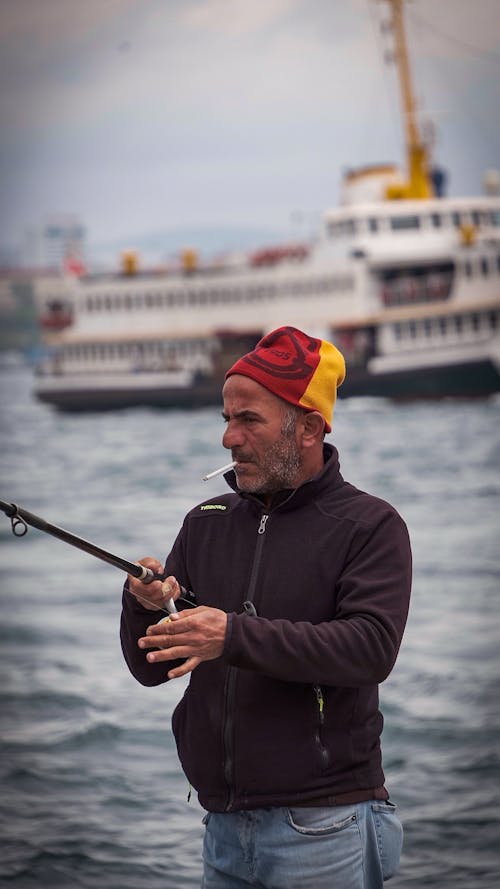 Old Man Fishing and Smoking