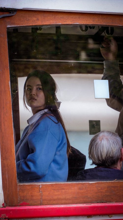 Woman Standing behind the Window 