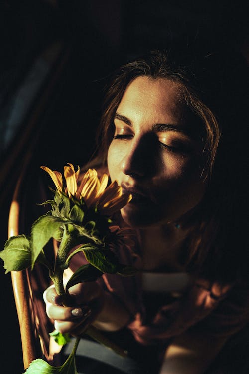 Woman with Flower in Dark