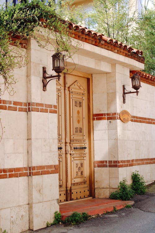 Ornate Wooden Doors in Stone Fence