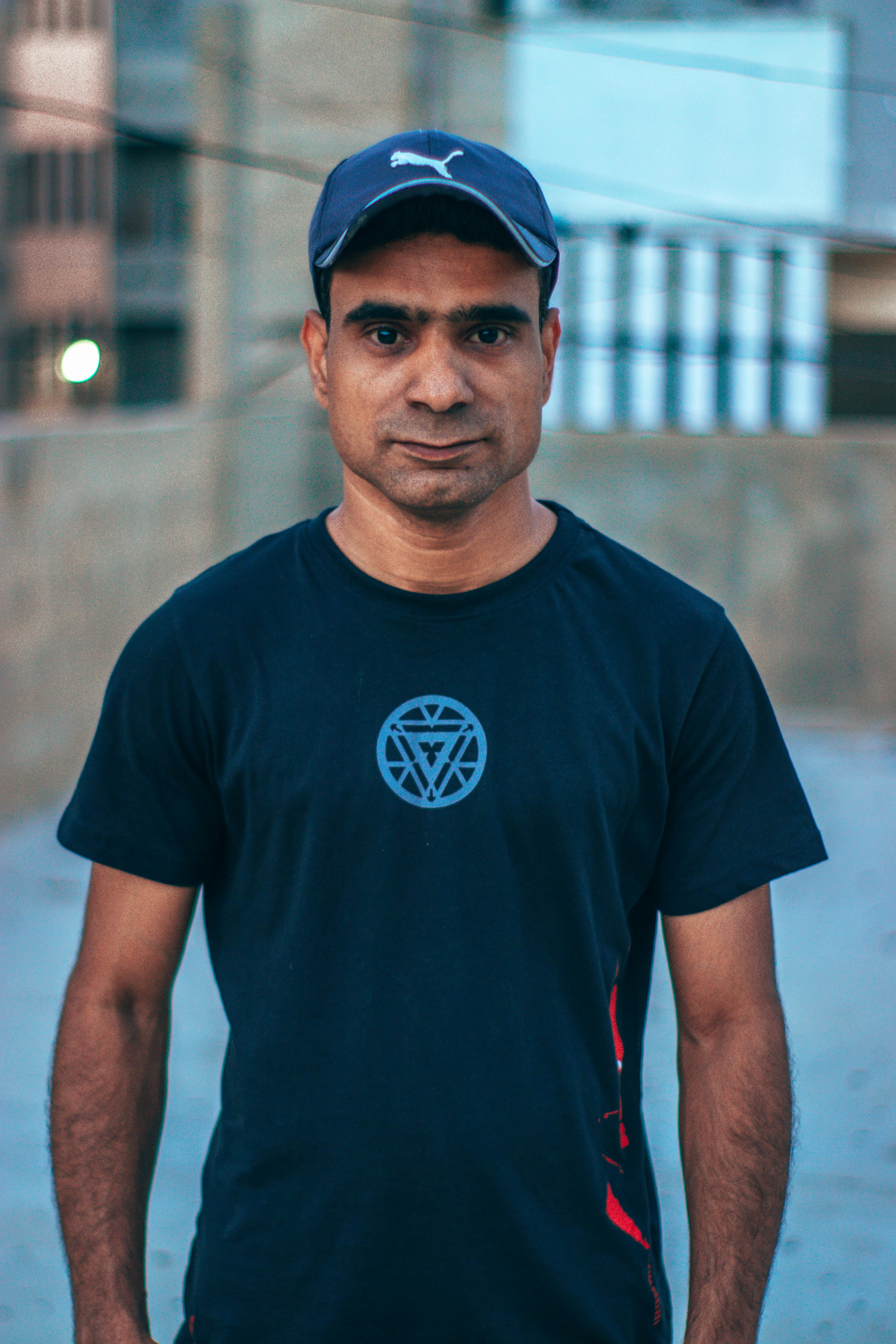 Portrait of a young man posing in sportswear on a city street.