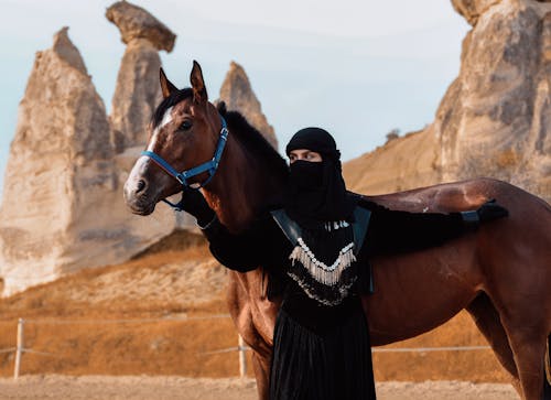 Bedouin Woman with a Horse in a Desert 