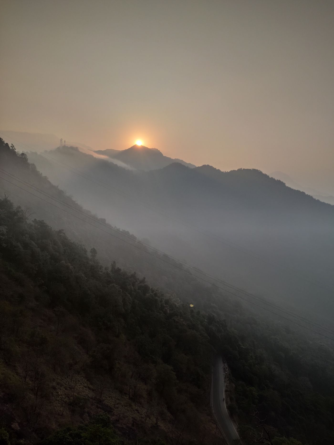Sun rising over misted hill ranges — Thekkady, representative image