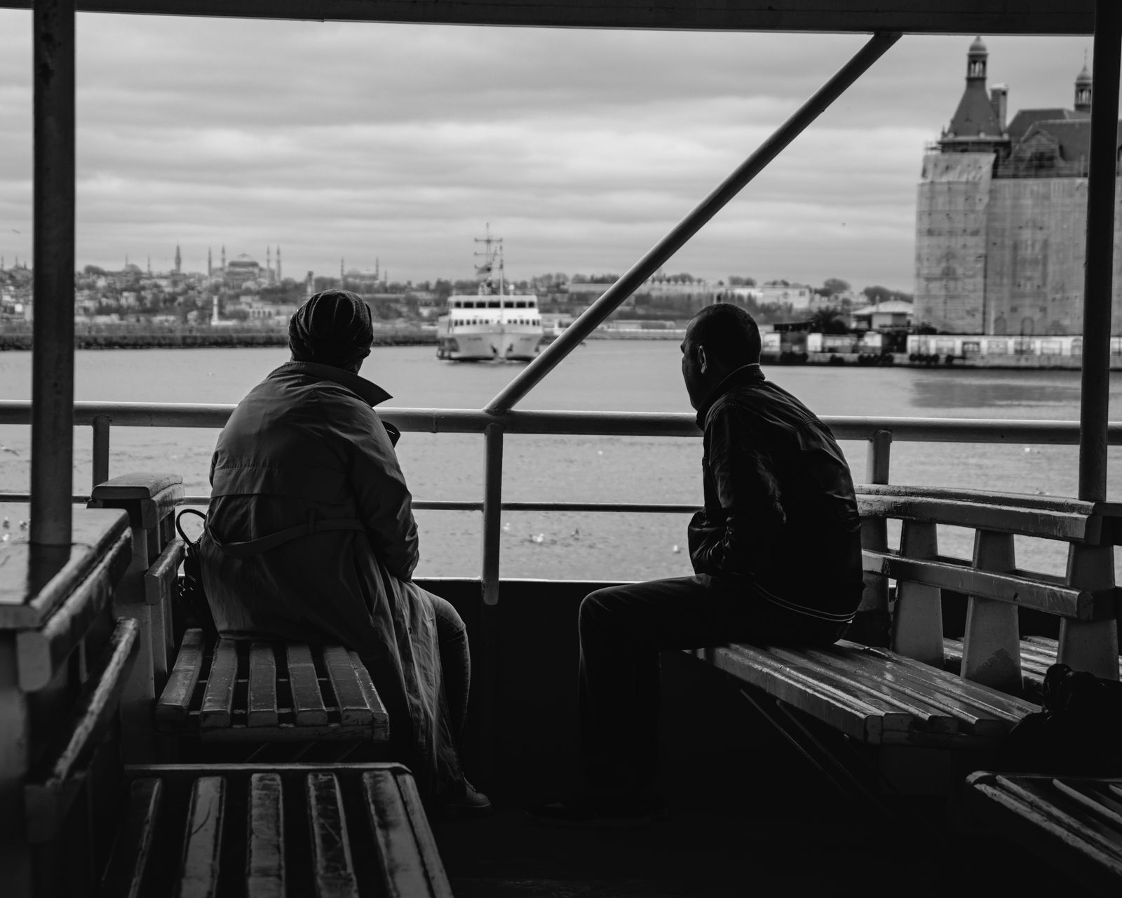 Passengers watching the waterfront from a ferry