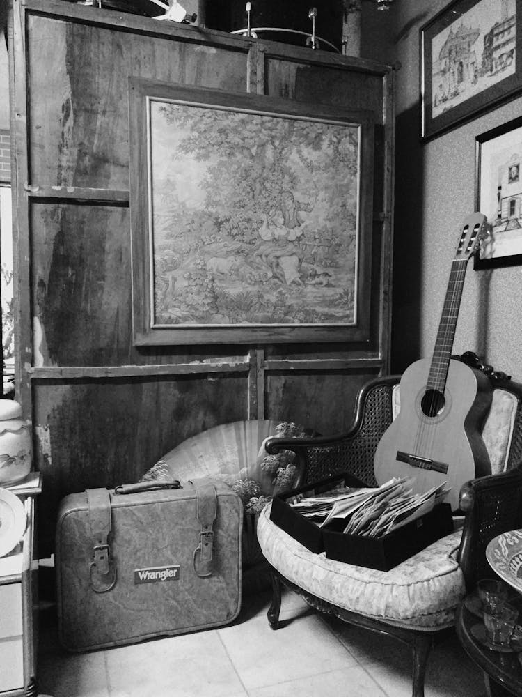 A Vintage Interior With Paintings And An Acoustic Guitar 