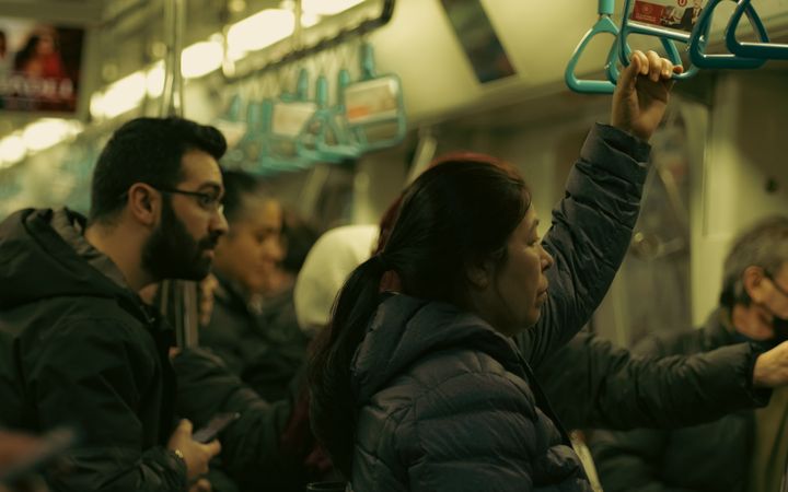 Crowded subway train with commuters standing during an urban travel commute.