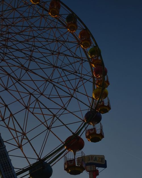 Free Stunning view of a Ferris wheel against a twilight sky, capturing its vibrant colors. Stock Photo
