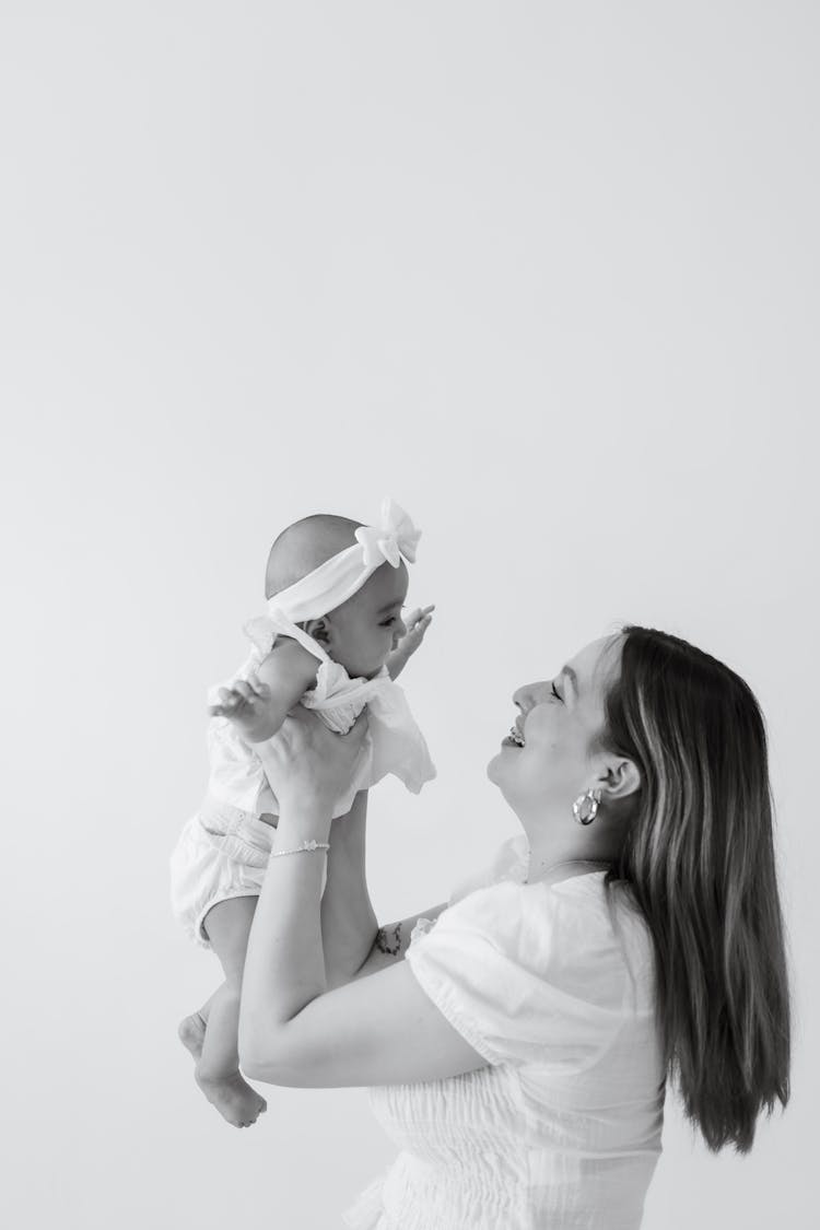 Mother Holding Baby In Black And White