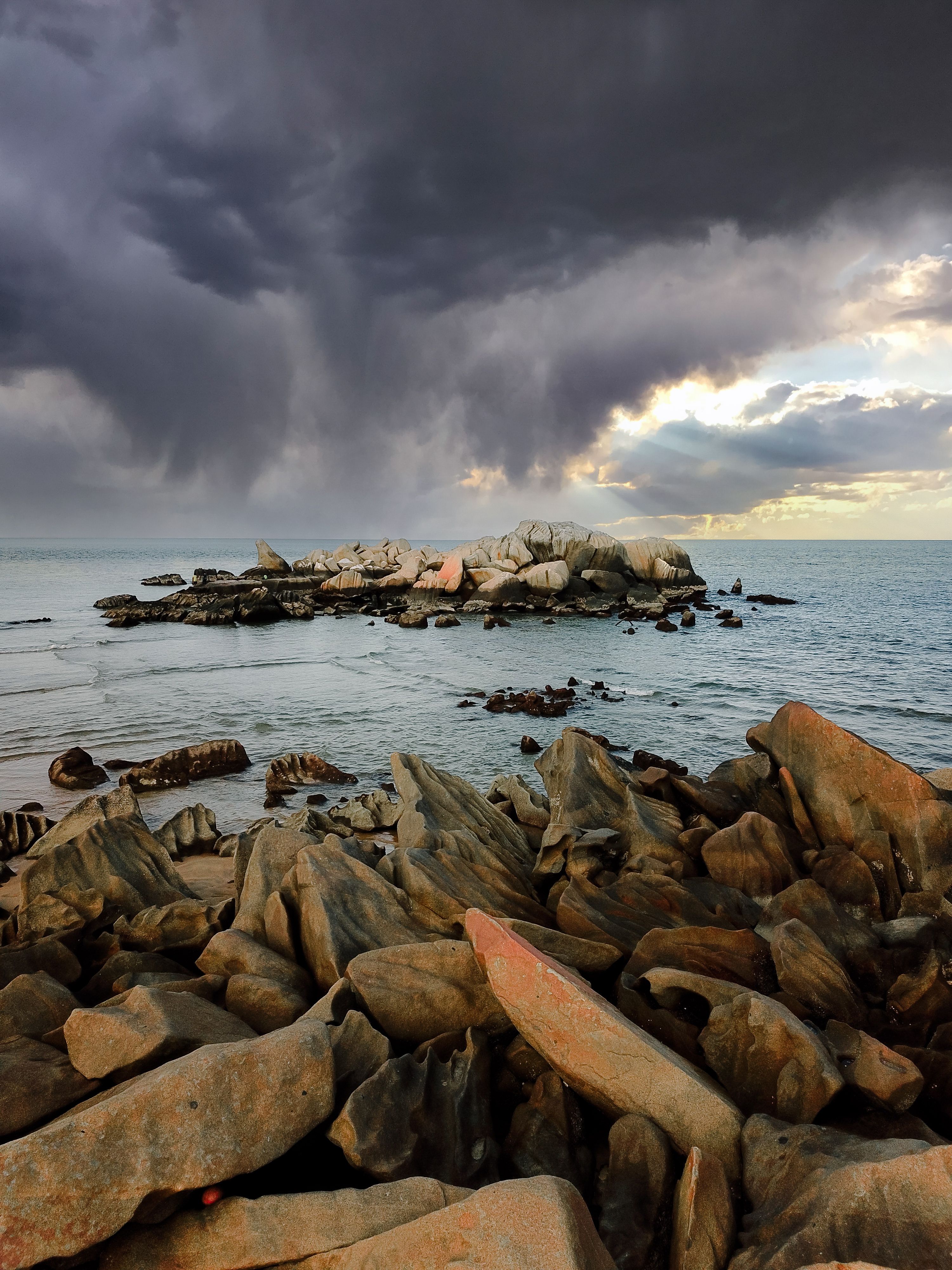 Dramatic Clouds over Rocky Coast · Free Stock Photo