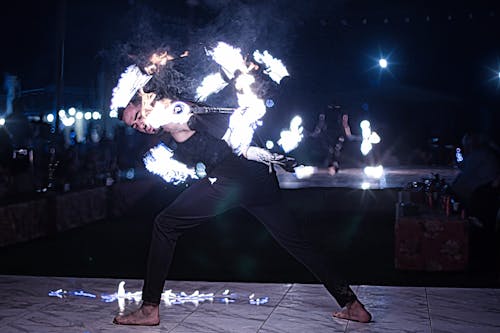 Man Performing with Fire on Stage
