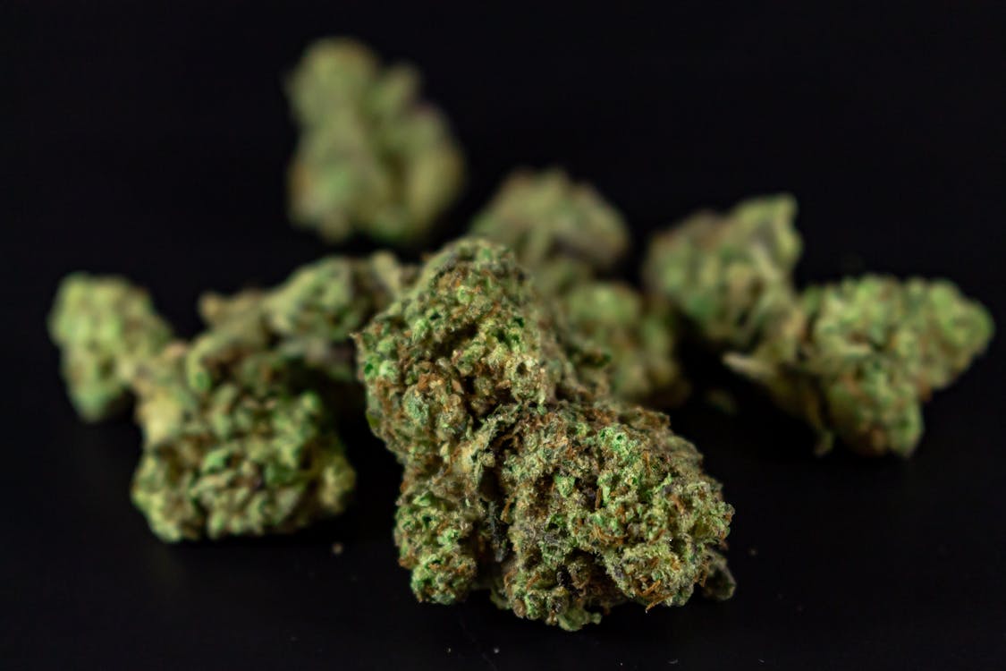 Free High-quality close-up image of cannabis buds against a dark background. Stock Photo