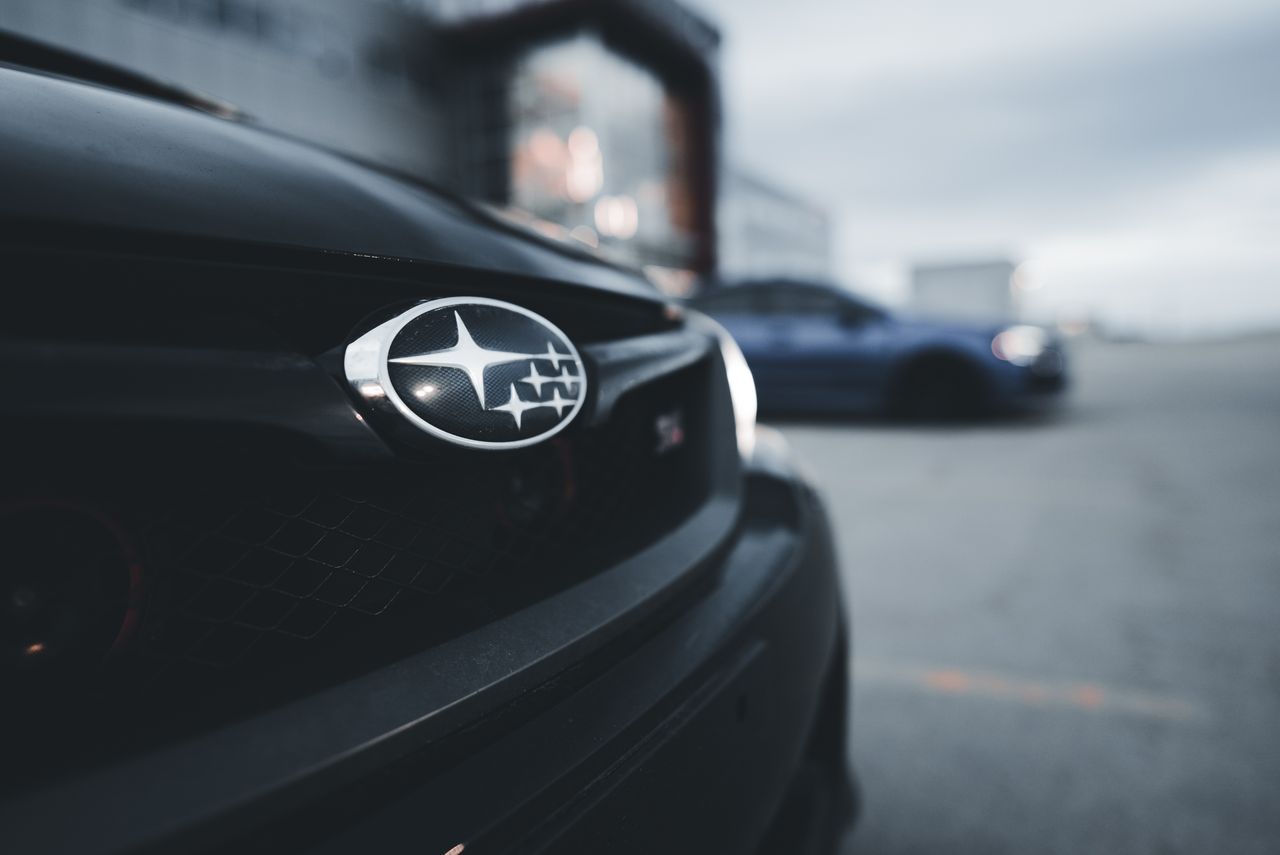 detail of a subaru wrx grille with an out of focus background featurin