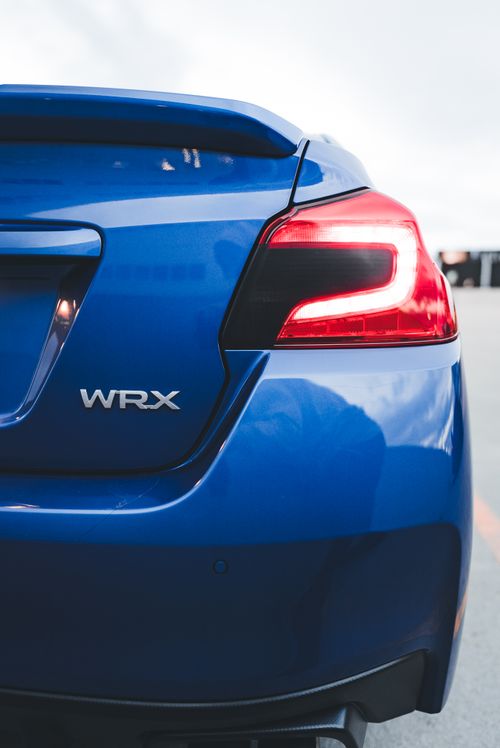 Free Close-up of a blue WRX sports car rear featuring taillight details in an outdoor setting. Stock Photo