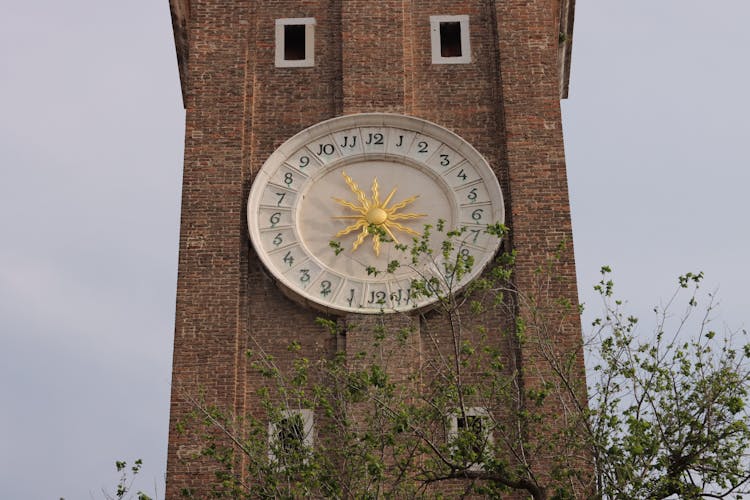 Close-up Of The Clock Tower Of The Santi Apostoli Church In Venice, Italy 