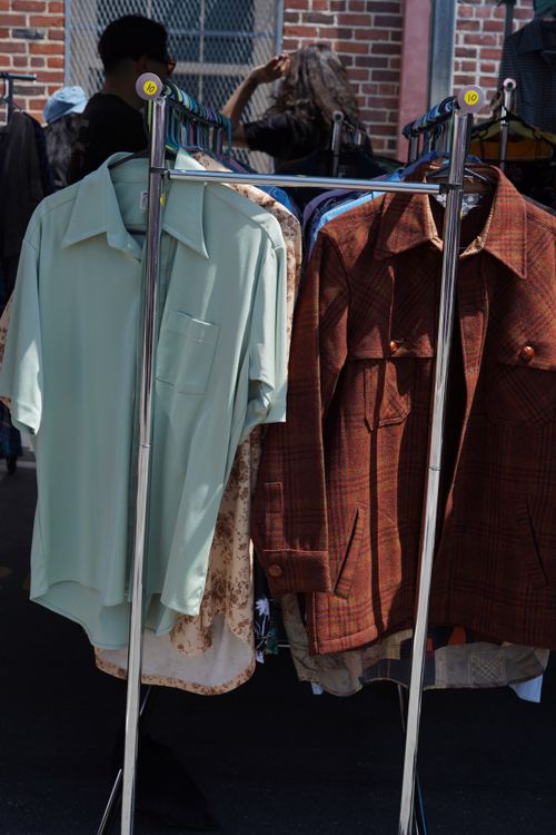 Free Vintage shirts hanging on a clothing rack at an outdoor market in Los Angeles, California. Stock Photo
