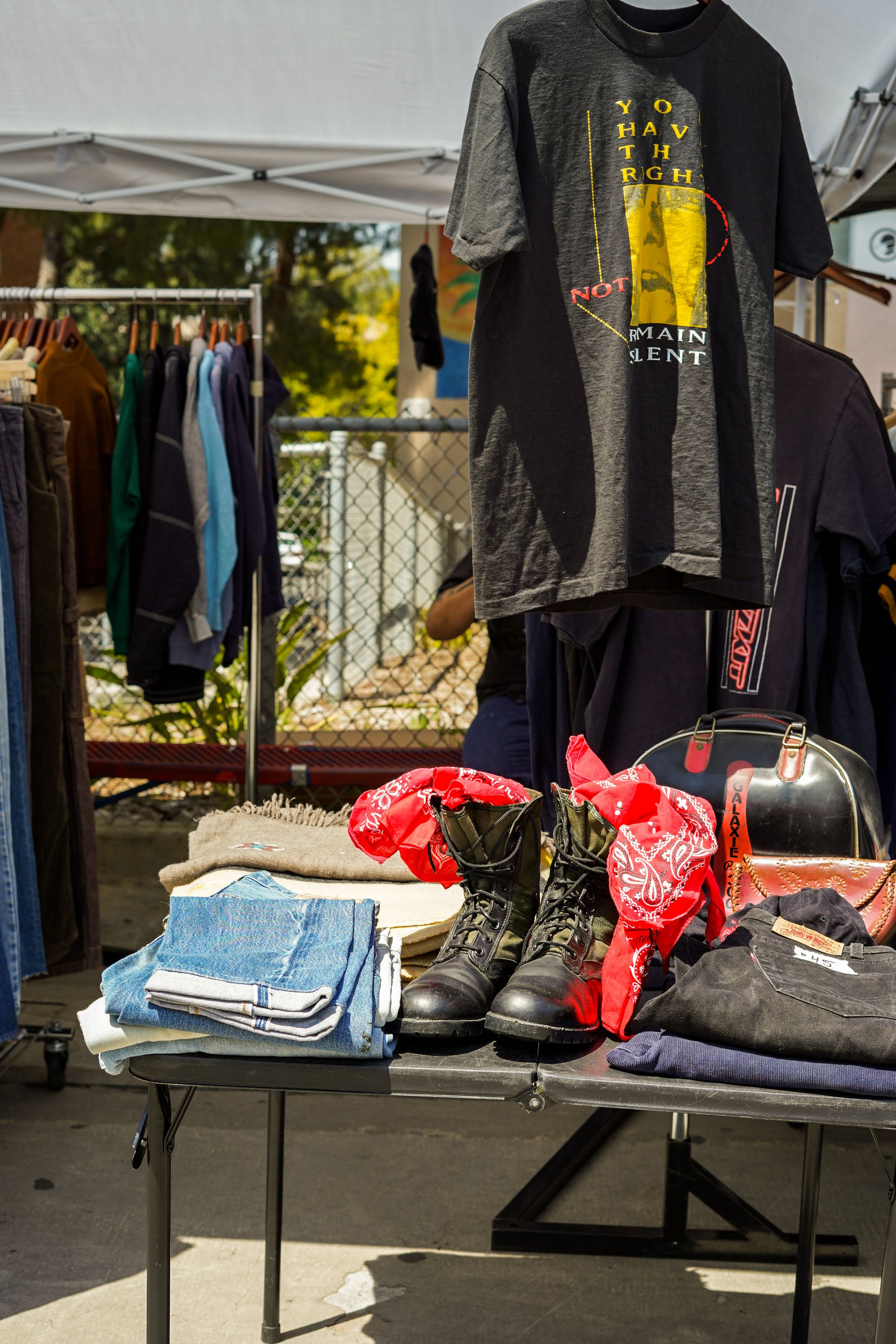 Vintage clothing and accessories displayed at an outdoor market