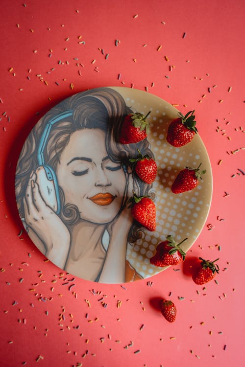 Strawberries on a Plate with an Illustration of a Woman