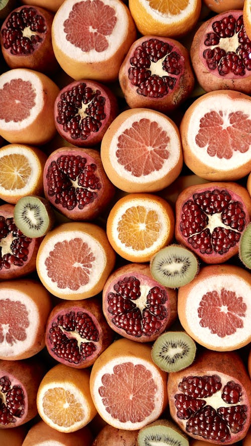 Top View of Fruit Halves: Kiwis, Oranges, Grapefruits, Pomegranates 